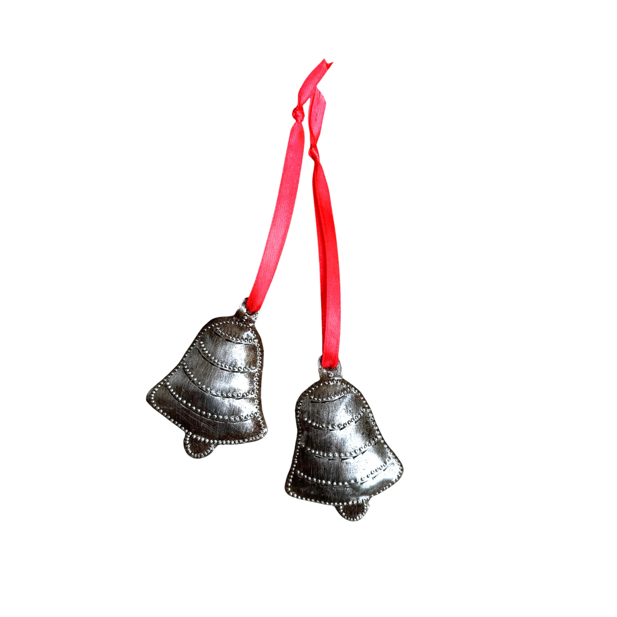 Brushed metal bell ornaments with red ribbon on white background.