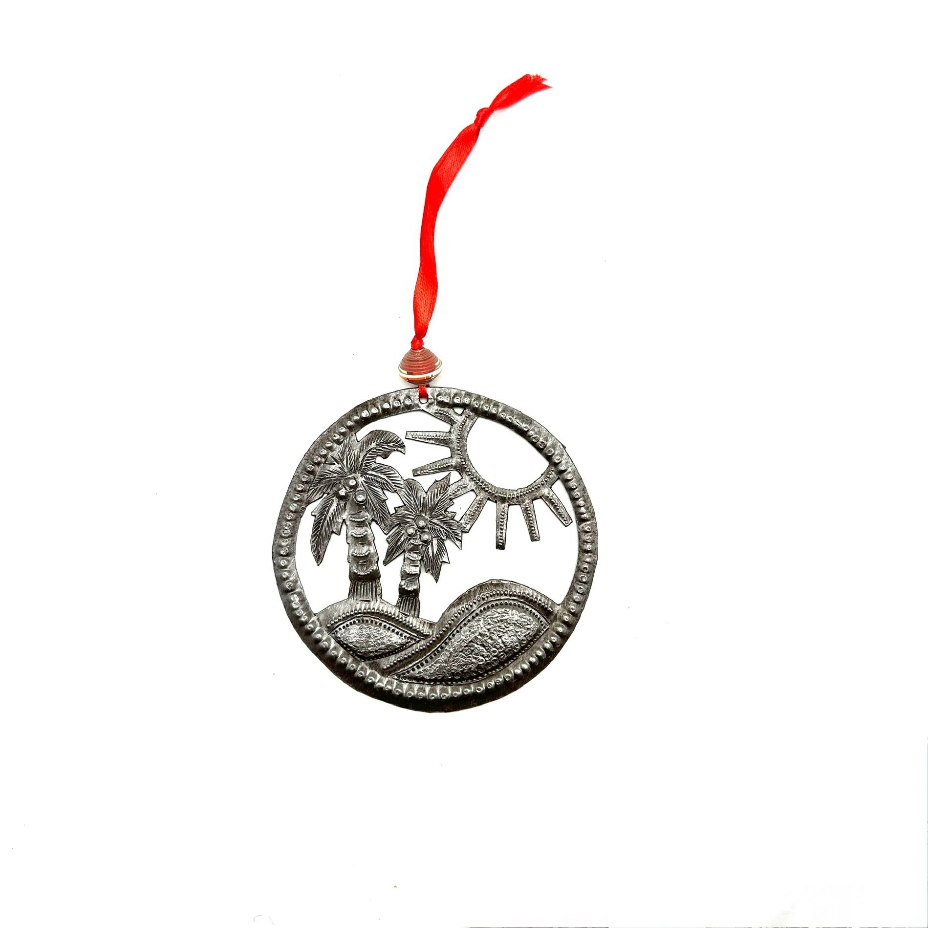 Palm tree Christmas ornament handmade from recycled steel drum by Haitian artisan